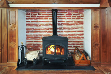 Rustic wood burning stove, wood burner, renewable ernergy heating in winter - Powered by Adobe
