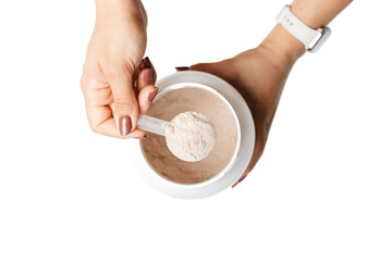 Woman's hand holding measuring spoon with portion of whey protein powder over a jar, making protein...