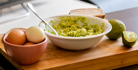 Avocado Mashing in a Bowl on Wooden Board