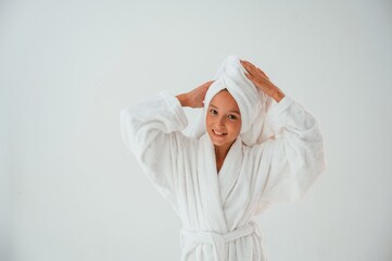 With towel on the head. Conception of beauty and self care. Young girl is in the studio