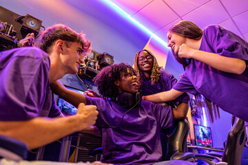 Team of multiracial professional cyber sports players celebrating success. © PintoArt