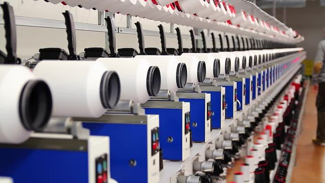 Textile Industry Production Manager Overseeing Thread Manufacturing Machines. Spinning Spools With Threads at Textile Factory. Thread Manufacturing in Textile Industry.