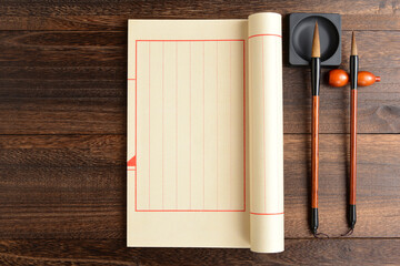 Ancient books and brushes placed on retro style wooden boards