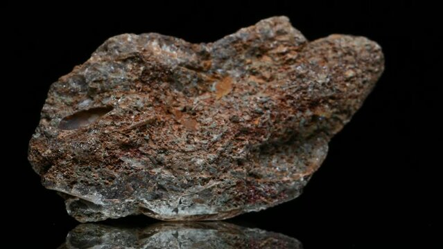 Limonite (iron oxide) sample rotating slowly against a black background.