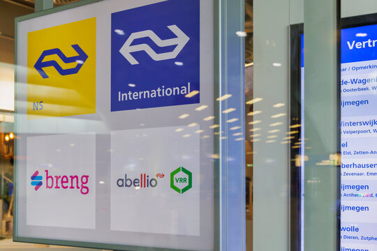 Commercial window sign with the logos of the Dutch railway and bus companies Nederlandse Spoorwegen, Breng and Abellio in Arnhem, The Netherlands on September 20, 2023