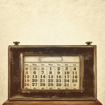 Sepia toned image of an ancient ornamental desk calendar