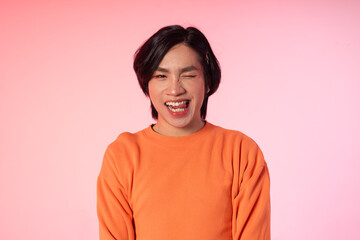 Portrait of gay man confidently posing on background