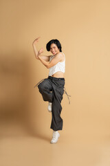 Image of Asian dancer dancing on beige background