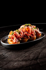 beef tongue with potatoes and mushroom sauce on plate