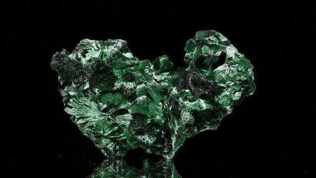 Fibrous Malachite (copper carbonate hydroxide) sample rotating slowly against a black background.