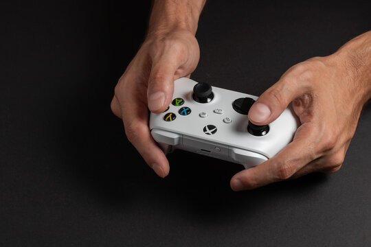30 August 2023, Dnipro, Ukraine: Xbox Series S controller on man hand on dark background.