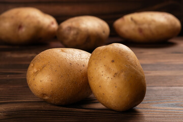Fototapeta na wymiar Fresh harvested potatoes on a rough wooden surface