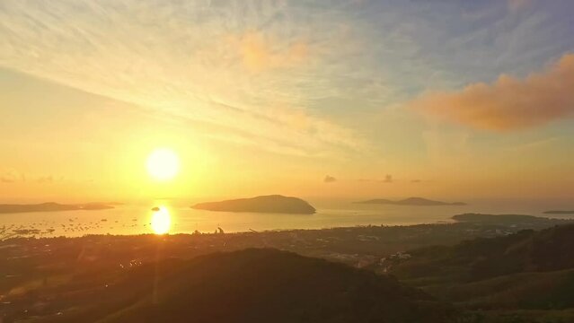aerial view golden sun above the ocean..cloud moving above the mountain in yellow sunrise..moving cloud at yellow sunrise above the ocean..nature seascape and yellow sky of sunset over the sea.