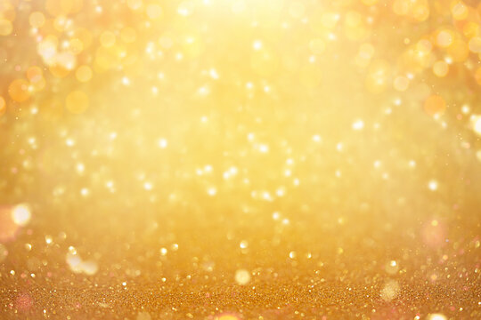 Defocused shining yellow bokeh background. Christmas texture.