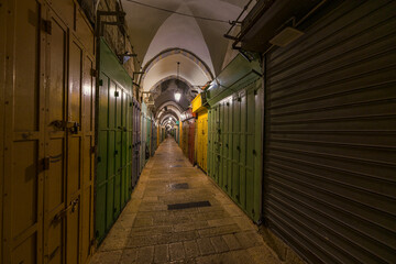 View at night, when every shop is closed, of a picturesque traditional market in Jerusalem Old City.
