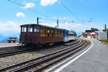Fototapeta premium Train transports tourists to the top of a mountain in Switzerland