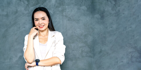 Portrait Asian businesswoman professional in grey business suit  on a gray background.Business stock photo.