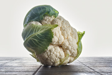 Fresh organic cauliflower on brown table. Shallow depth of field