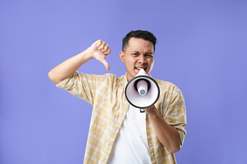 Photo of Asian man using megaphone for protests, calling to action.