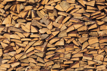 Wall of firewoods as a texture.the split logs put together one on another. Pile of wood logs ready for winter. Wood logs texture background