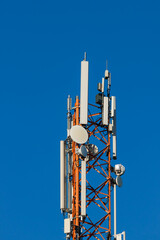 Communications tower with antennas on blue sky