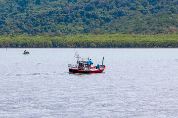 The sea, mountains and local fishing boats are sailing.