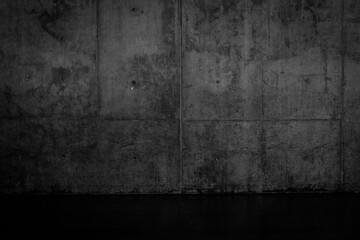 Grungy dark concrete wall and wet floor