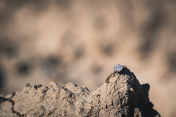 diamond engagement ring resting on top of a rock