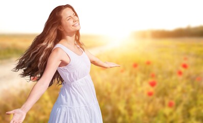 Young happy woman outstretched arms and breathing fresh air