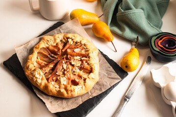 Freshly baked galette with pear on baking paper