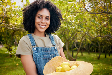 Woman in orchard, portrait and agriculture with lemon in nature, healthy food and nutrition with...