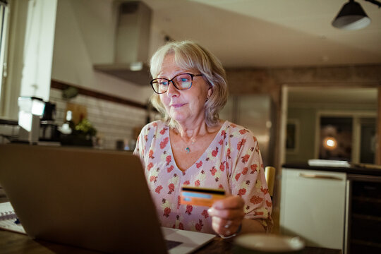 Senior woman online shopping on her laptop at home