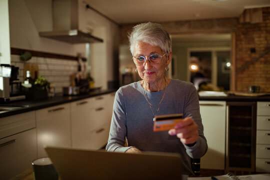Senior woman online shopping on her laptop at home