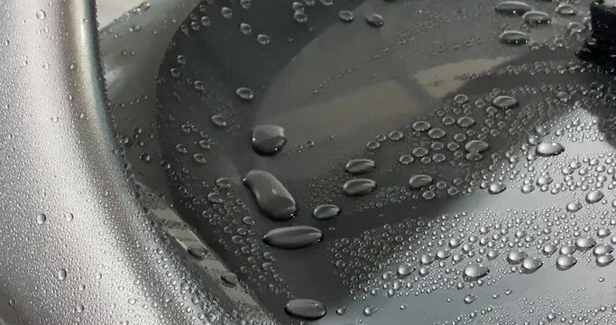 Hydrophobe on the car body. Car body coated with ceramic compound repels water. Car detailing video
