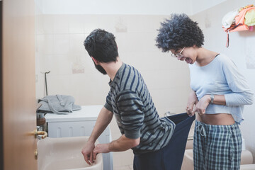 Affectionate young multiethnic couple havign fun joking bathroom