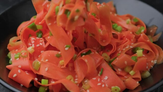 Eating Asian carrot salad with spices and herbs