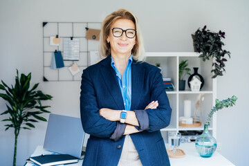 Portrait of smiling 50's stylish, confident mature businesswoman, middle aged company ceo director, experienced senior female professional, business coach team leader in modern office. Female leader. - obrazy, fototapety, plakaty