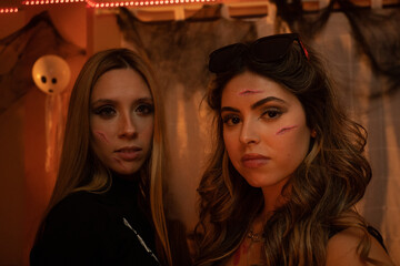 European Halloween party in a friends apartment- -Images of Young adults celebrating Halloween. The...