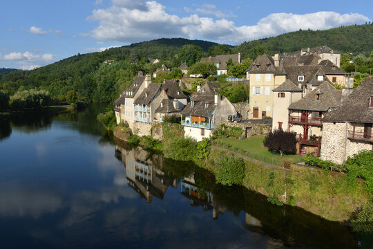 little idyllic town of Argentat-sur-Dordogne with Dordogne River and reflections in quiet water