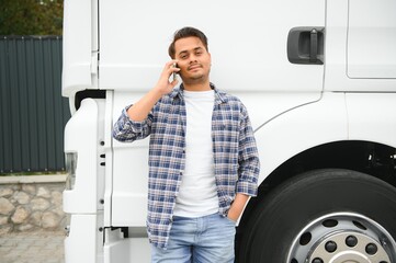 Indian truck driver tending a client on the phone.