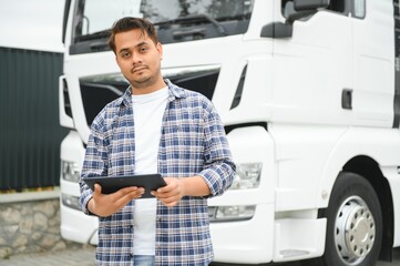 Young indian businessman with his freight forward lorry or truck.