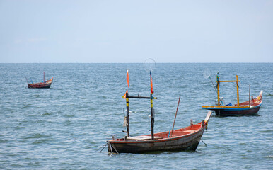 Fototapeta na wymiar Fishing boats used to catch fish Located on sea water with slight waves. Used to find food for people who earn a living catching fish. For those who live next to the sea
