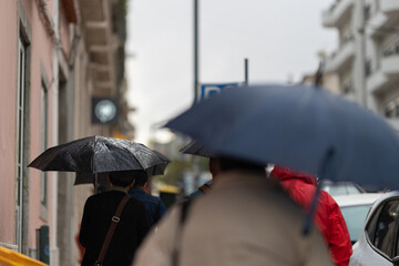 People walking with umbrellas in the rain