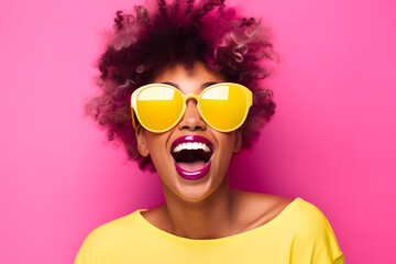 Colorful studio portrait of a young african-american woman laughing happily, yellow and pink. Copy space