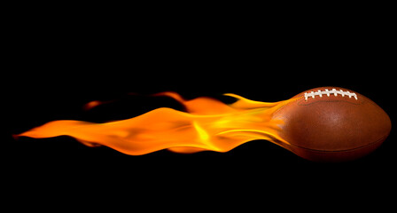 A flaming American football against a black background © CMANNPHOTO