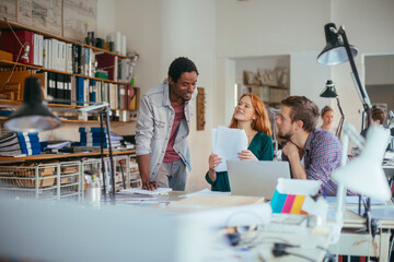Young and diverse group of architects working on a project together in a startup company office
