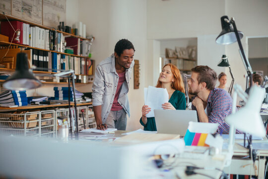 Young and diverse group of architects working on a project together in a startup company office