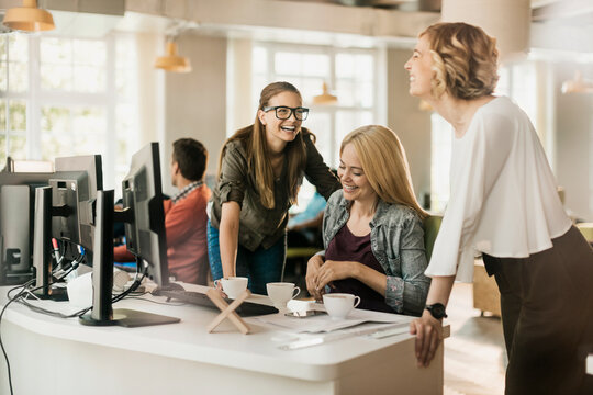 Young female colleagues having a coffee break together in the office
