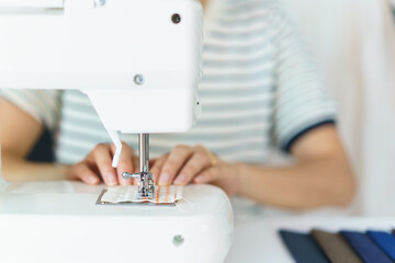 Happy beautiful Asian young woman working in the fashion design studio, professional female fashion designer portrait in design studio.