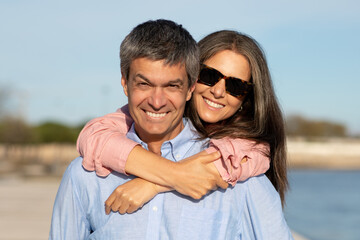 Fototapeta premium Portrait Of Beautiful Happy Mature Couple Posing Outdoors Near Sea